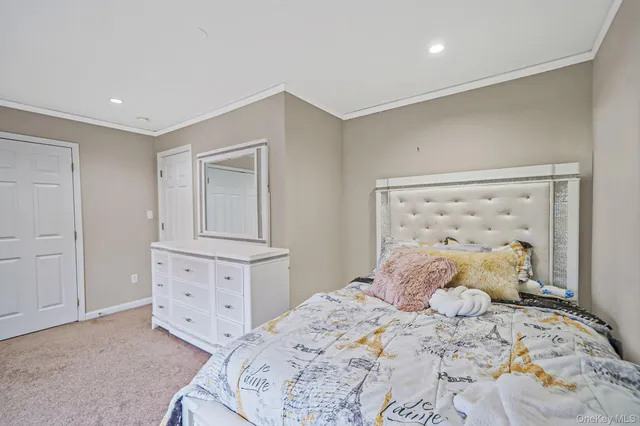 a bedroom with a bed and a potted plant