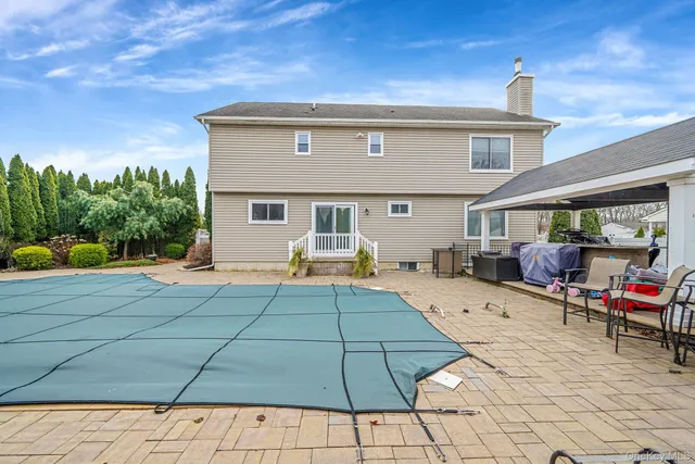 a view of a house with backyard porch and sitting area