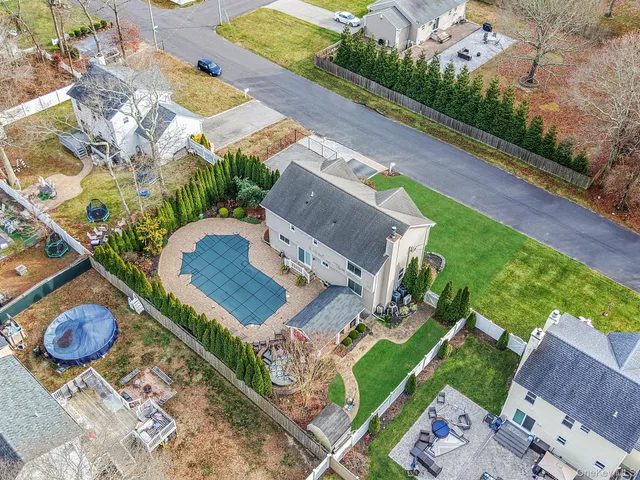 an aerial view of a house with garden space and street view