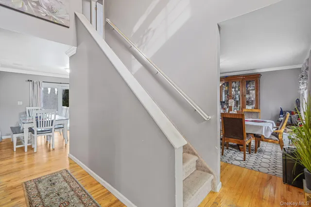 a view of a livingroom with furniture wooden floor and a kitchen