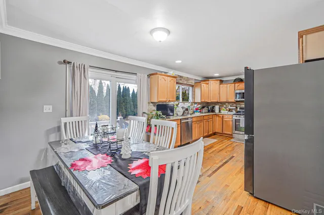 a very nice looking dining room with kitchen island granite countertop a refrigerator and a stove