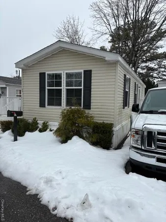 a view of a house with a yard covered in snow