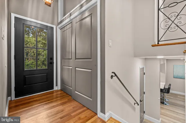 a view of a hallway with wooden floor and staircase