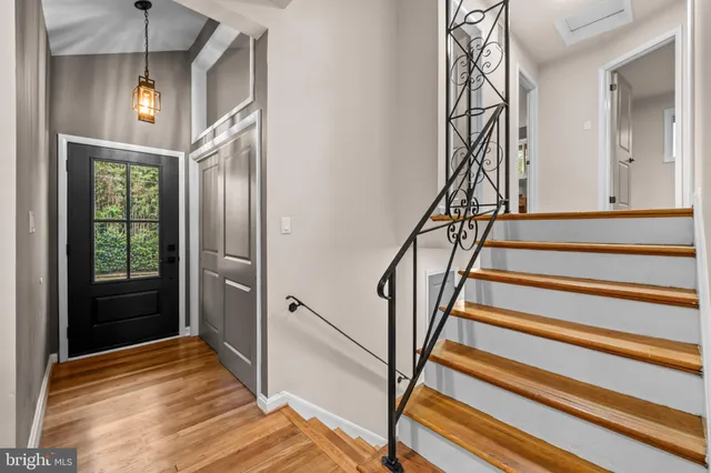 a view of entryway and hall with wooden floor