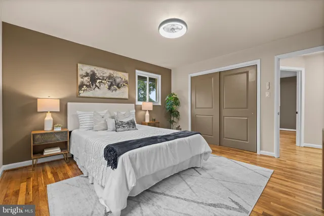 a bedroom with a bed and a painting on the wall