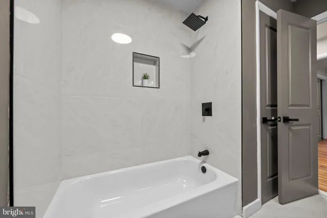 a en suite bathroom with a double vanity sink a large mirror and a shower