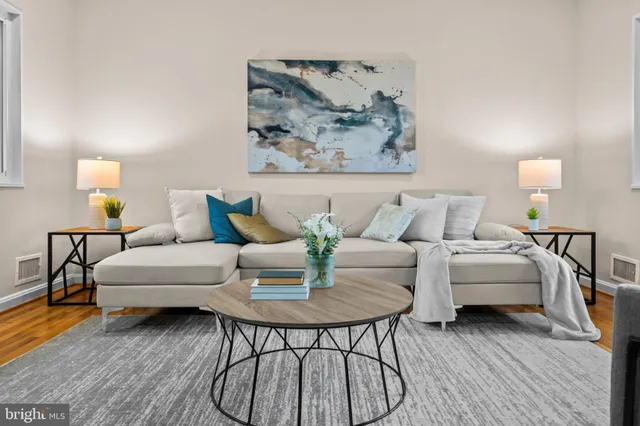 a living room with furniture and wooden floor