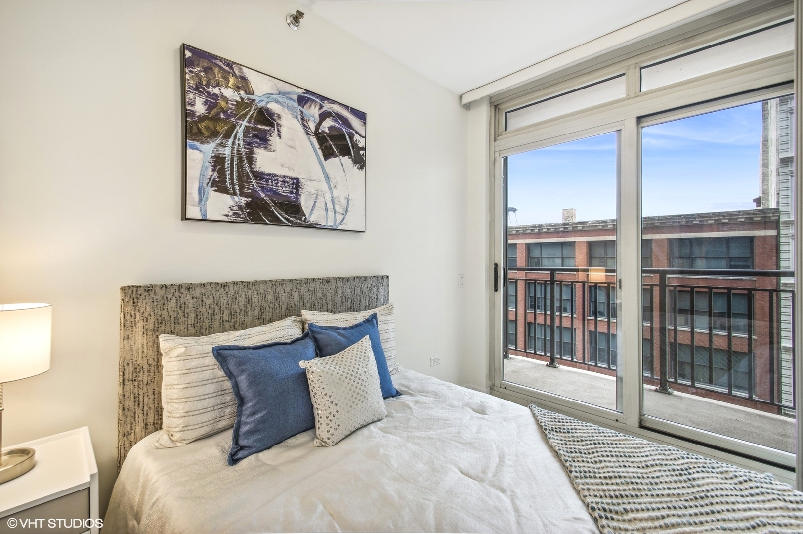 1111 South Wabash Avenue, Unit 706 Chicago, IL 60605 - Photo 12 of 19 a bedroom with a large bed and a window