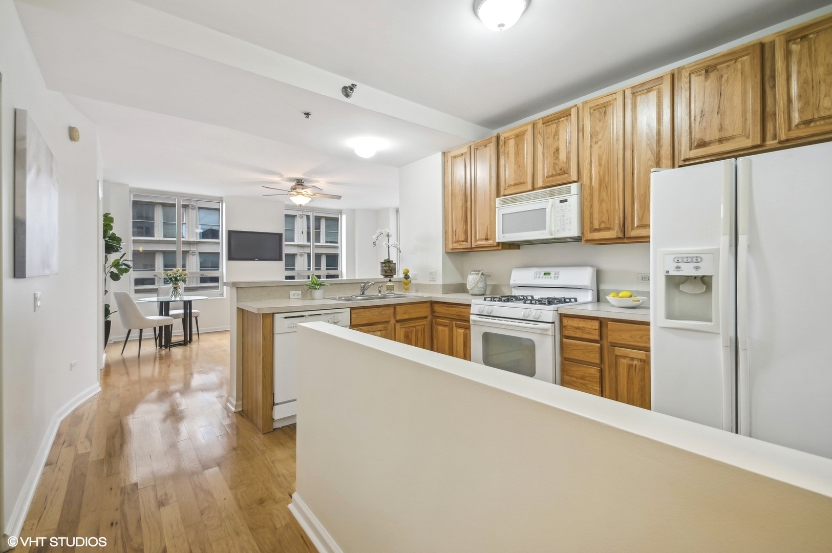1111 South Wabash Avenue, Unit 706 Chicago, IL 60605 - Photo 7 of 19 a kitchen with granite countertop a refrigerator a stove top oven and cabinets