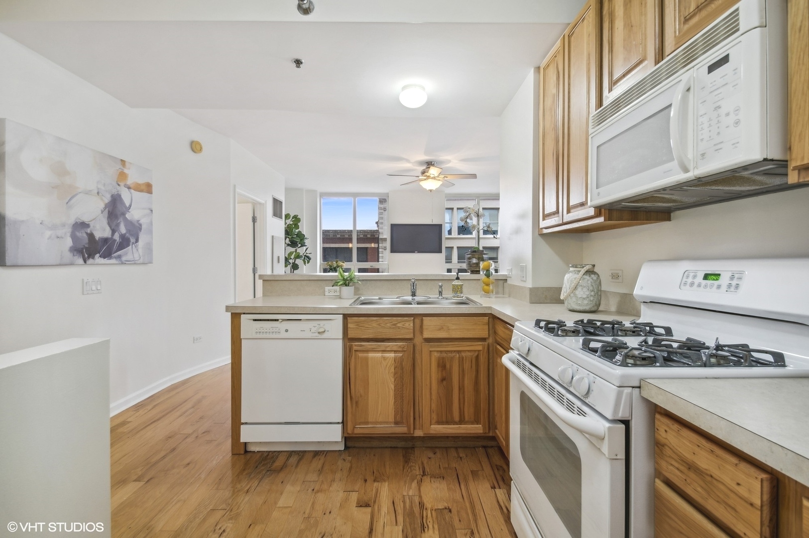 1111 South Wabash Avenue, Unit 706 Chicago, IL 60605 - Photo 8 of 19 a kitchen with stainless steel appliances granite countertop a stove and a white cabinets