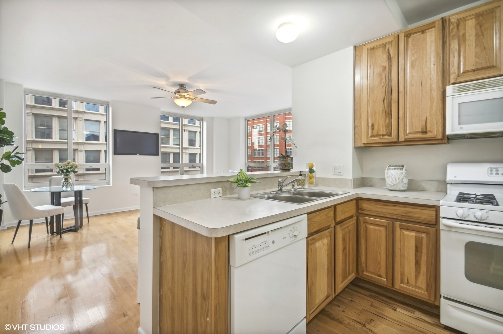 1111 South Wabash Avenue, Unit 706 Chicago, IL 60605 - Photo 10 of 19 a kitchen with a sink stove and cabinets