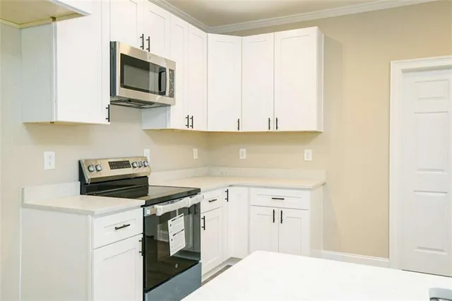 a kitchen with a sink stove and microwave