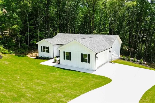 a aerial view of a house with swimming pool and yard