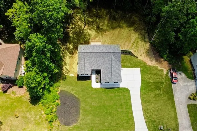 a aerial view of a house with swimming pool garden and patio