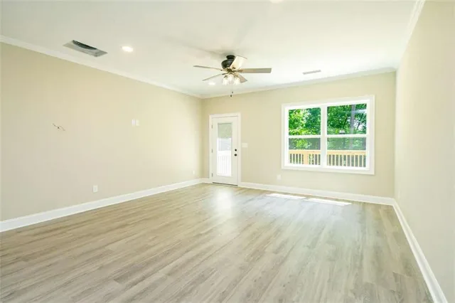 wooden floor in an empty room with a window