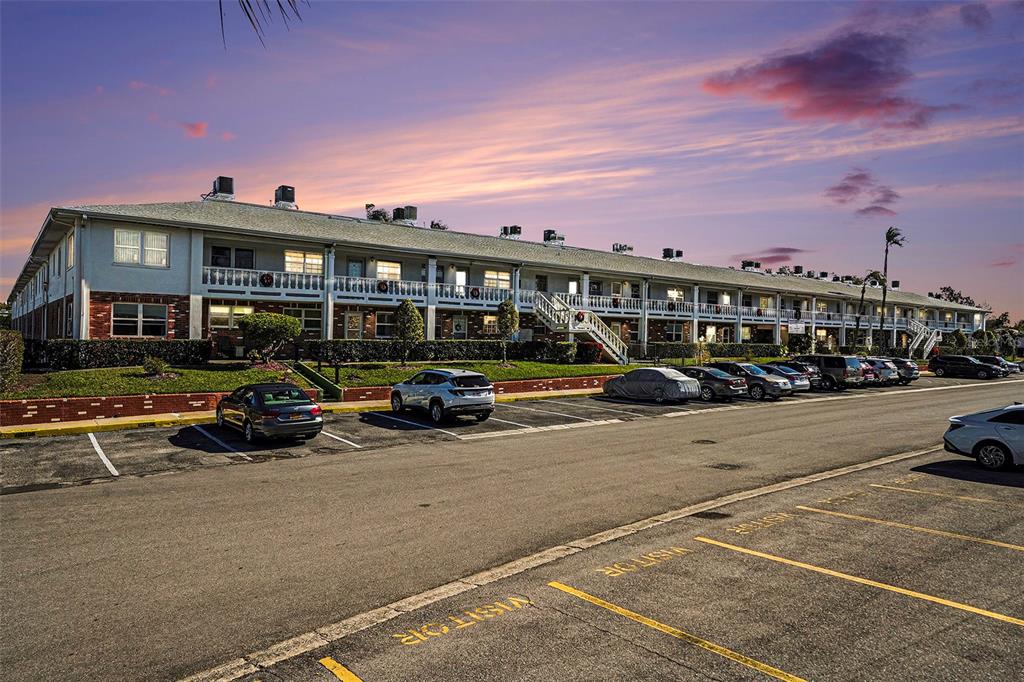 a view of a cars park in front of a building