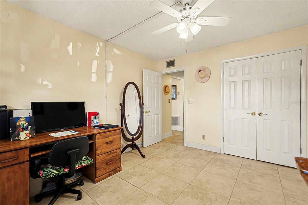 4742 Azalea Drive, Unit 103 New Port Richey, FL 34652 - Photo 22 of 33 a view of a workspace with furniture and a flat screen tv