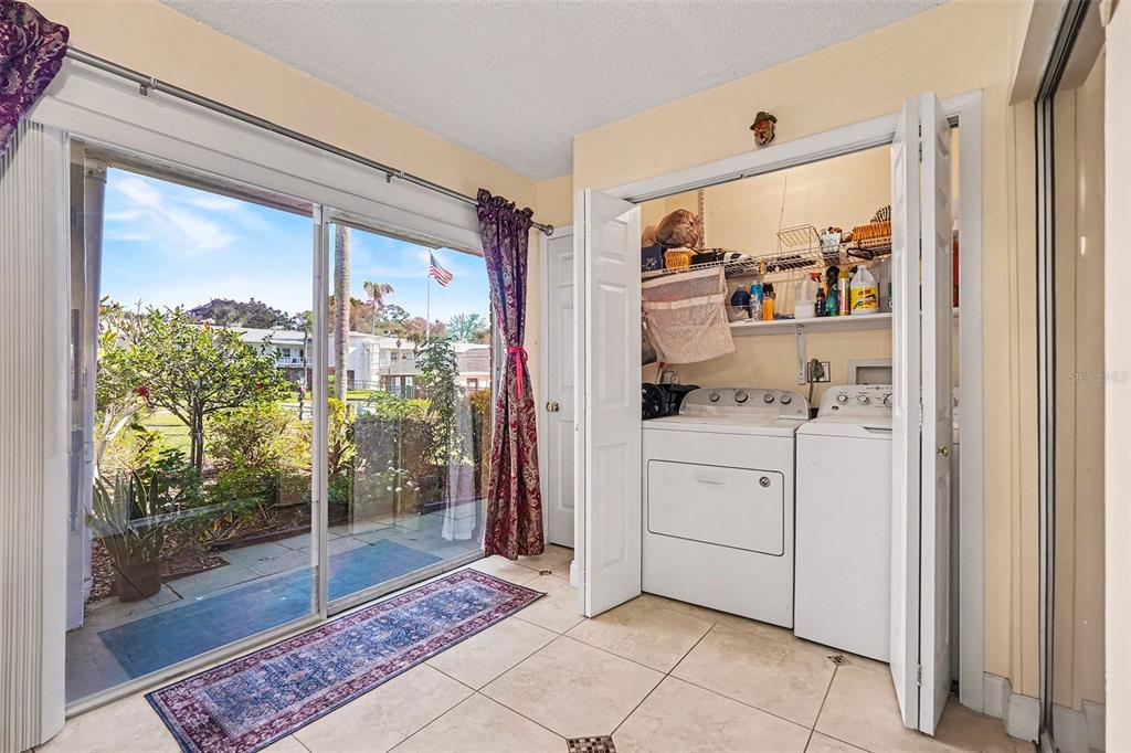 4742 Azalea Drive, Unit 103 New Port Richey, FL 34652 - Photo 23 of 33 a room with washing machine and cabinets