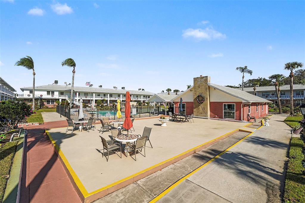 4742 Azalea Drive, Unit 103 New Port Richey, FL 34652 - Photo 26 of 33 a view of a terrace with chairs