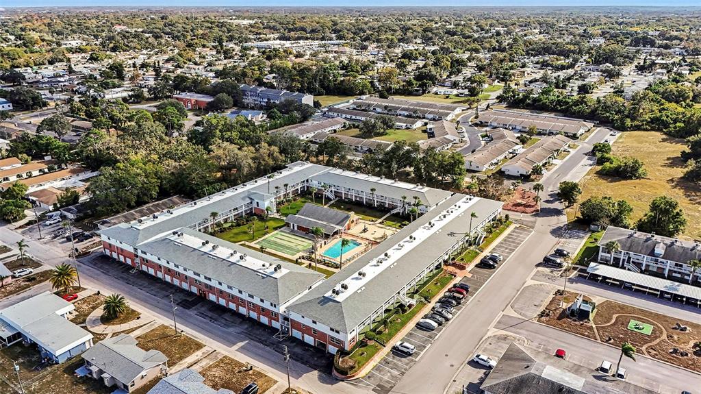4742 Azalea Drive, Unit 103 New Port Richey, FL 34652 - Photo 29 of 33 an aerial view of a residential apartment building with a pool