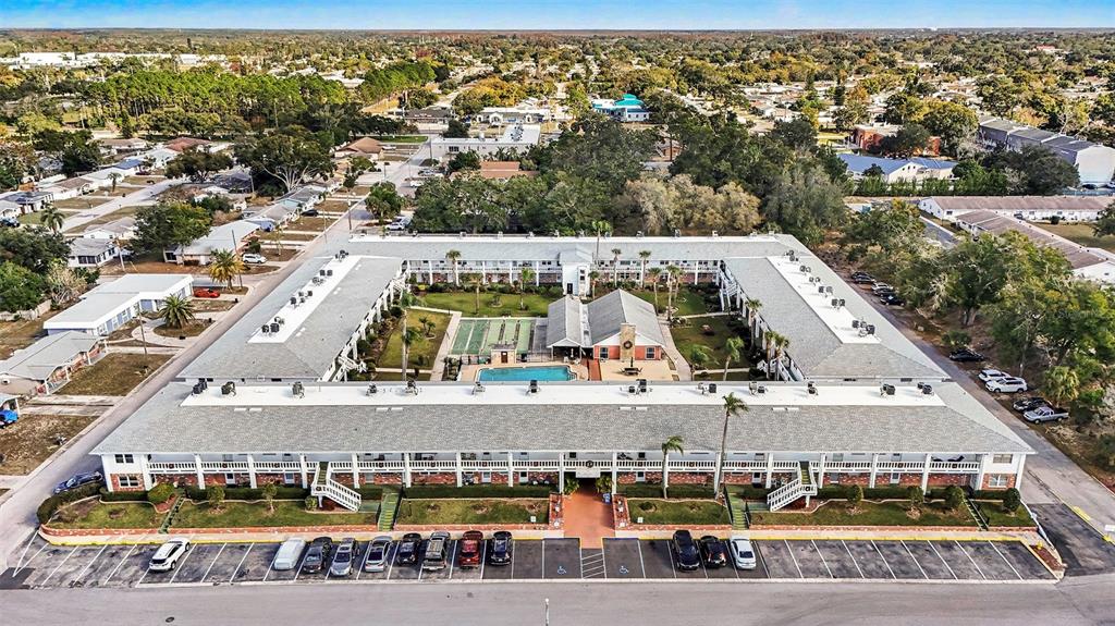 4742 Azalea Drive, Unit 103 New Port Richey, FL 34652 - Photo 30 of 33 an aerial view with streets and trees