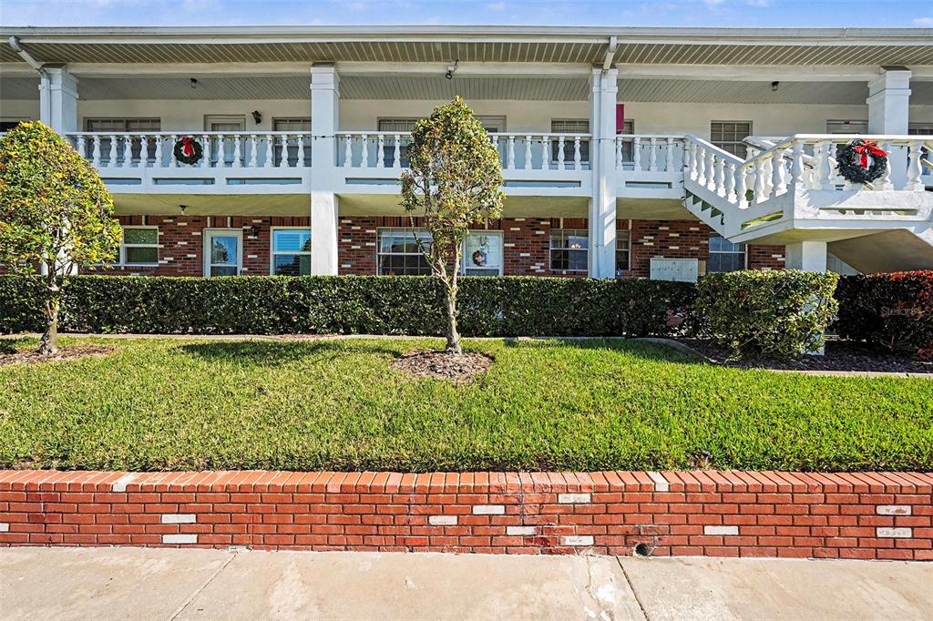 4742 Azalea Drive, Unit 103 New Port Richey, FL 34652 - Photo 3 of 33 a view of a building with a garden