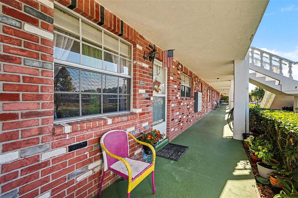 4742 Azalea Drive, Unit 103 New Port Richey, FL 34652 - Photo 4 of 33 a view of a chairs and table in the balcony