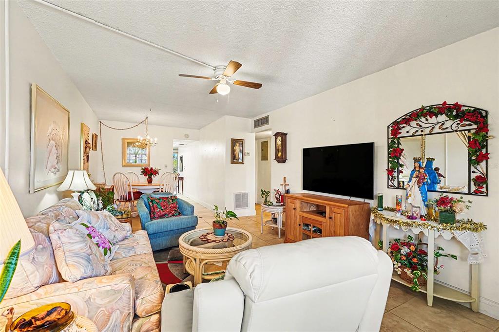 4742 Azalea Drive, Unit 103 New Port Richey, FL 34652 - Photo 6 of 33 a living room with furniture and a flat screen tv