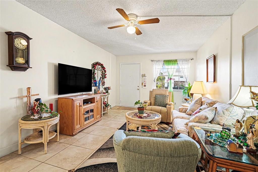 4742 Azalea Drive, Unit 103 New Port Richey, FL 34652 - Photo 7 of 33 a living room with furniture and a flat screen tv