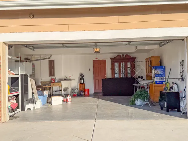 a front view of a house with a garden and trees