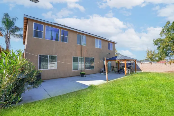 a bathroom with a granite countertop toilet sink and mirror