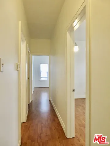 a view of a hallway with wooden floor