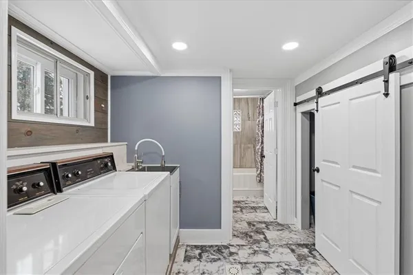 a room with two washing machine and wooden floor