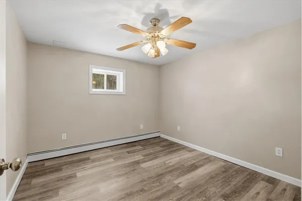 a view of empty room with wooden floor