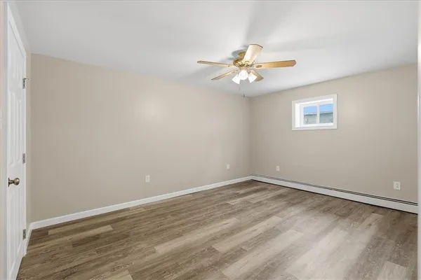 wooden floor in an empty room with a window