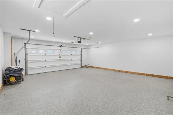 a view of an empty room with cabinet and a window