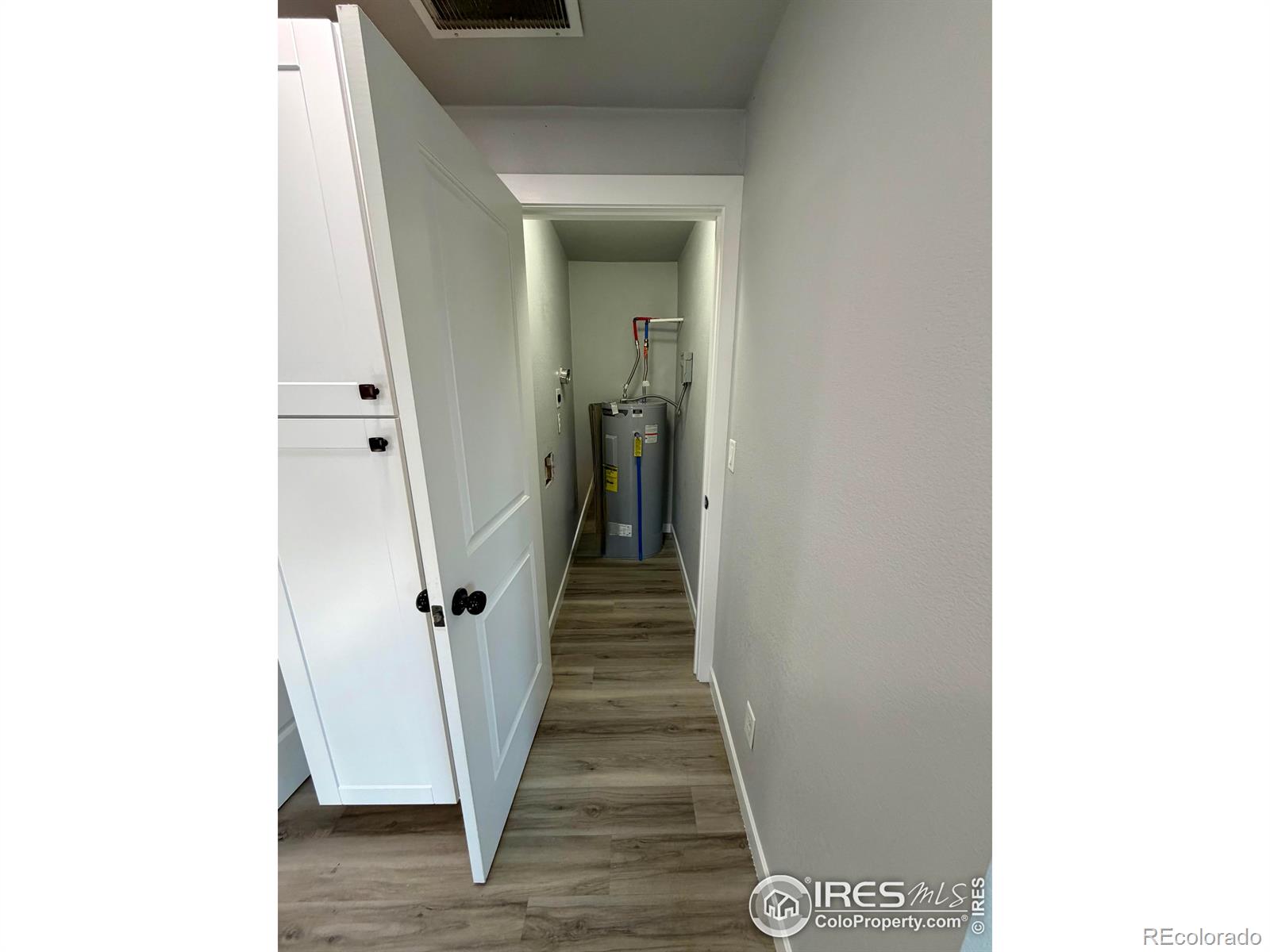 2015 5th Avenue, Unit A Greeley, CO 80631 - Photo 9 of 15 a view of a hallway with wooden floor and stairs