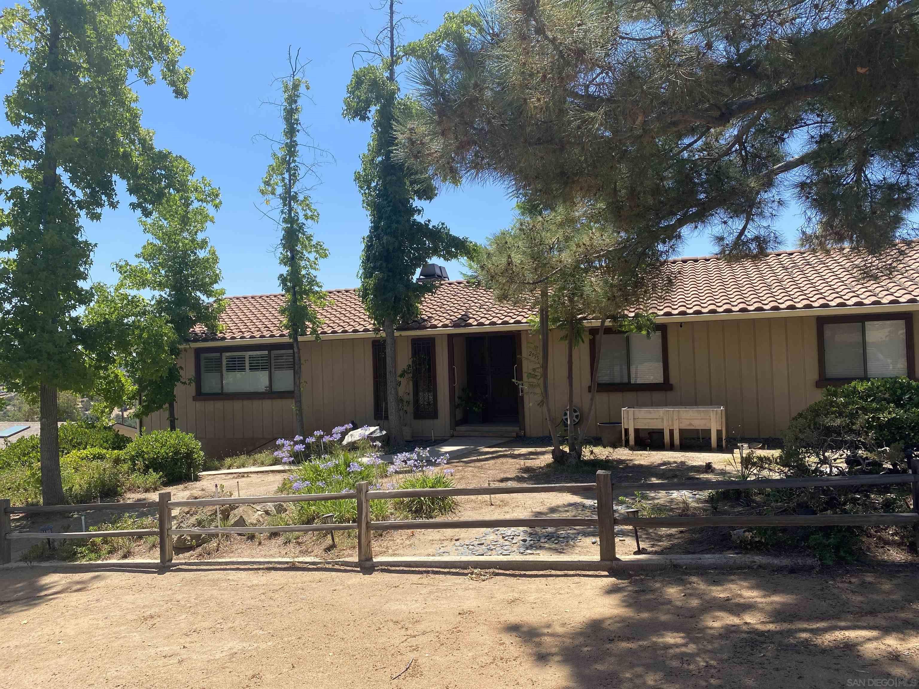 a view of a house with yard and sitting area