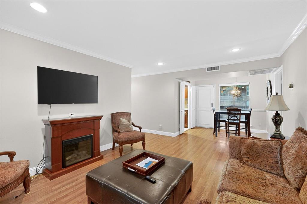 10534 Stone Canyon Road, Unit 111 Dallas, TX 75230 - Photo 1 of 14 a living room with furniture a fireplace and a flat screen tv