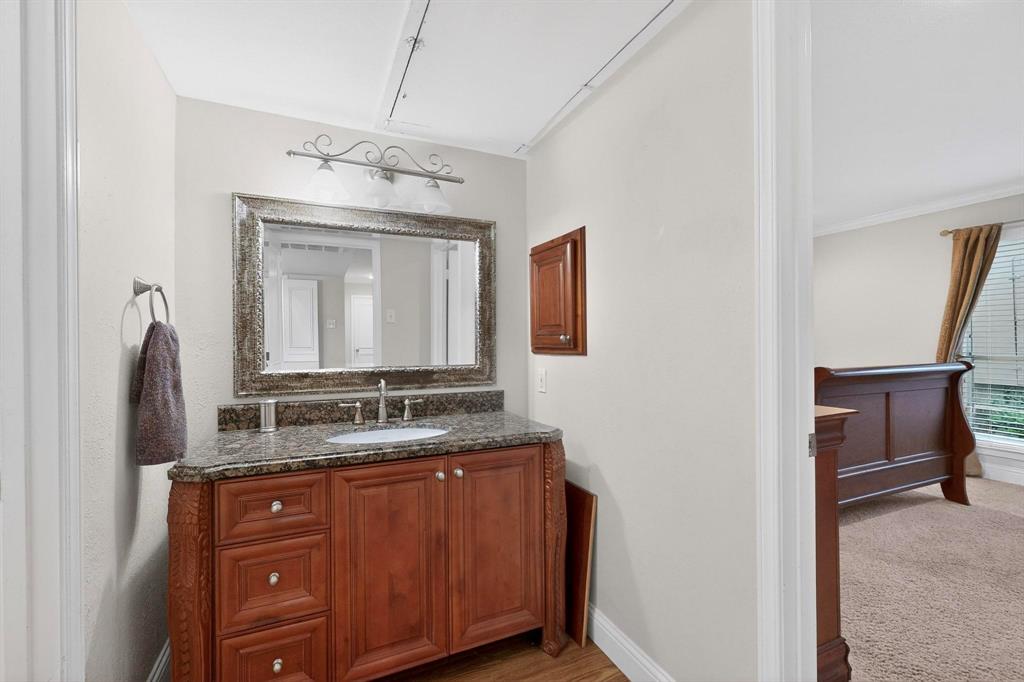 10534 Stone Canyon Road, Unit 111 Dallas, TX 75230 - Photo 11 of 14 a bathroom with a granite countertop sink and a mirror