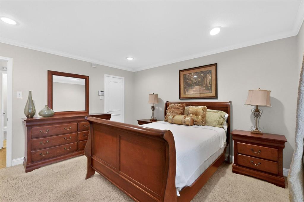 10534 Stone Canyon Road, Unit 111 Dallas, TX 75230 - Photo 8 of 14 a bedroom with a bed and a dresser