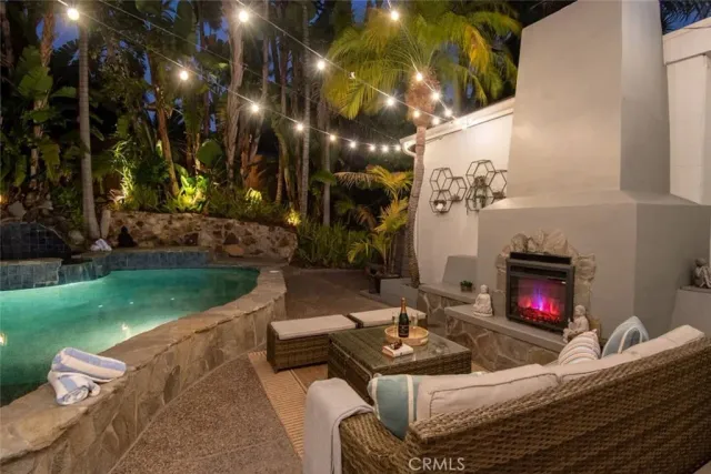 a living room with furniture a flat screen tv and a wall painting