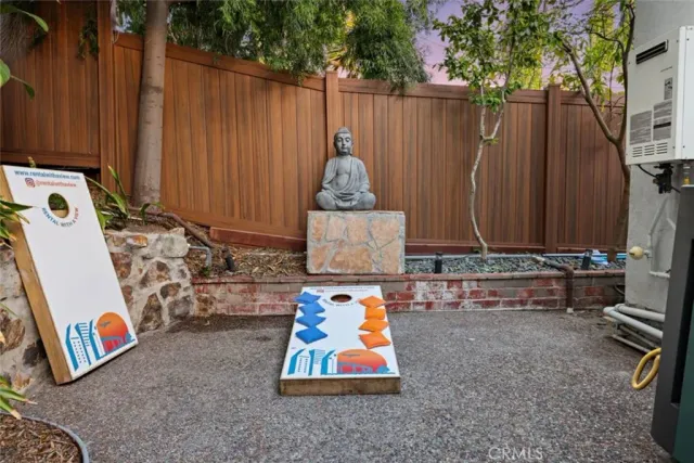a living room with furniture a flat screen tv and a wall painting