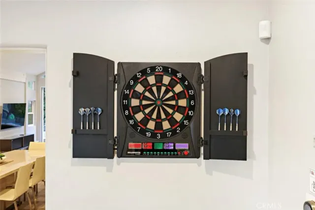 a room with furniture pool table and window