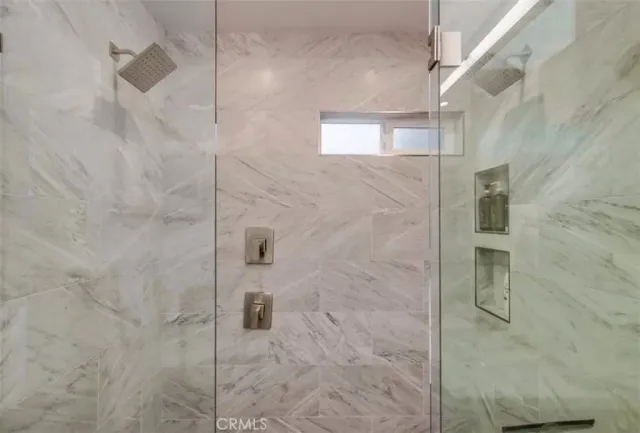 a living room with furniture a lamp and large window