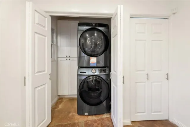 a kitchen with a refrigerator sink and cabinets