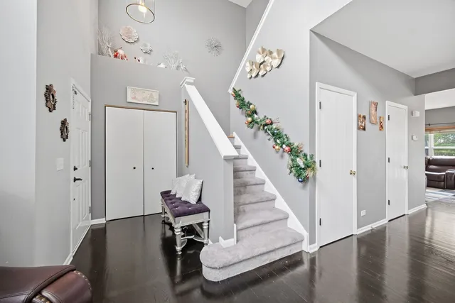 a view of entryway and hall with wooden floor