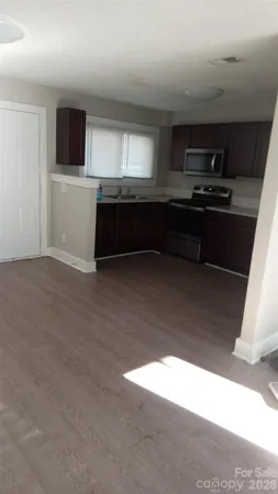 a kitchen with stainless steel appliances granite countertop a refrigerator stove and microwave