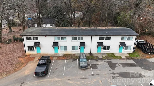 a view of a patio with a table and chairs under an umbrella