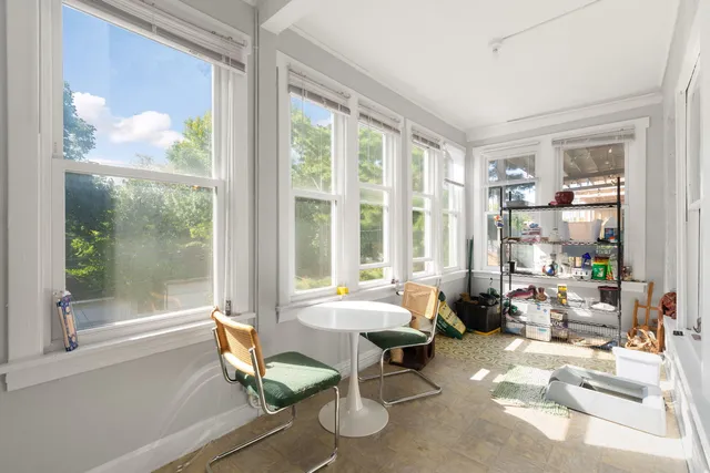 a living room filled with furniture and a large window